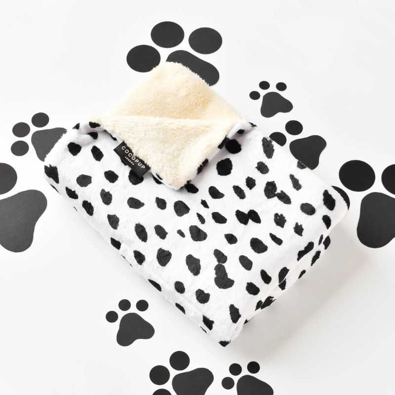 Our Monochrome Spots Dog Blanket is super soft with a fluffy lining it will keep your pup cosy, warm and stylish too.