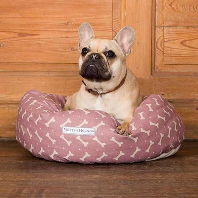 Linen Bones Donut Dog Bed. Let your dog cuddle up and relax in this beautiful Linen Bones Donut Dog Bed. It is super comfy and perfect for dogs that love to curl up whilst they sleep! Made using a natural cotton canvas fabric with a cute bone print design.